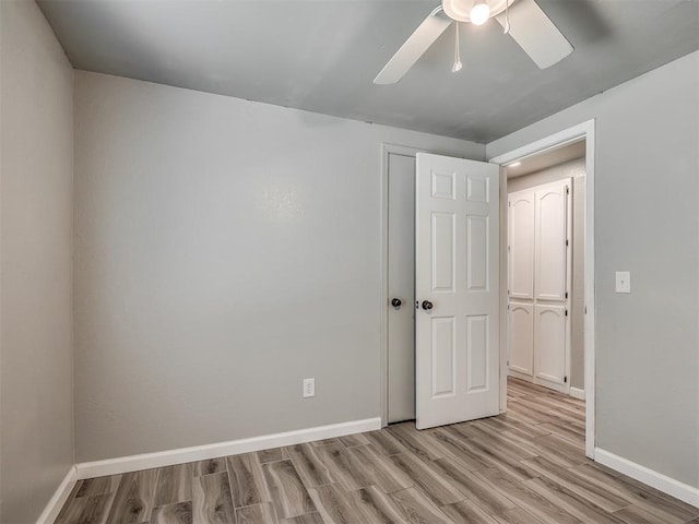 813 Branchwood Ct, Norman, OK 73072 - unfurnished bedroom featuring wood finished floors, baseboards, and ceiling fan