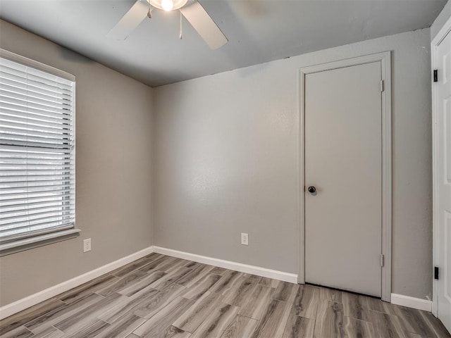 813 Branchwood Ct, Norman, OK 73072 - empty room featuring light wood-type flooring, ceiling fan, and plenty of natural light