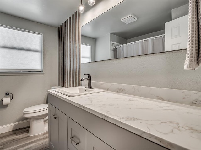 813 Branchwood Ct, Norman, OK 73072 - bathroom featuring toilet, wood finished floors, baseboards, and vanity