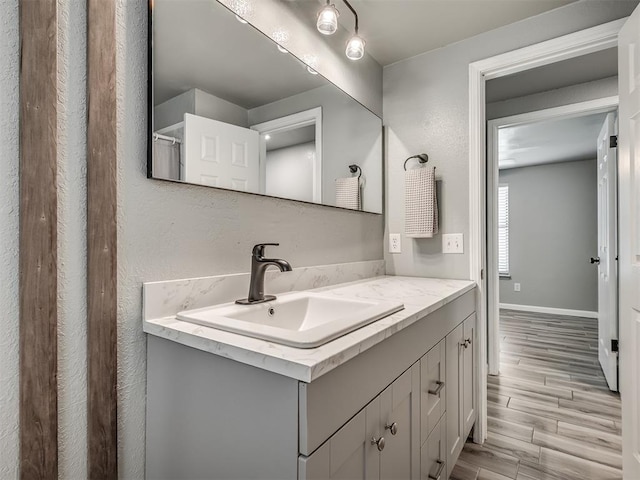 813 Branchwood Ct, Norman, OK 73072 - bathroom with wood finished floors, vanity, and baseboards
