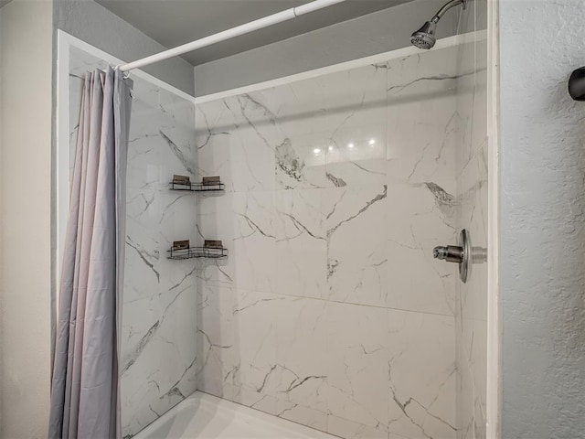813 Branchwood Ct, Norman, OK 73072 - bathroom featuring a shower with shower curtain and a textured wall