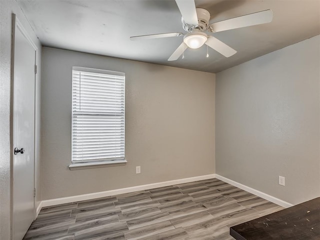 813 Branchwood Ct, Norman, OK 73072 - unfurnished room featuring wood finished floors, a ceiling fan, and baseboards