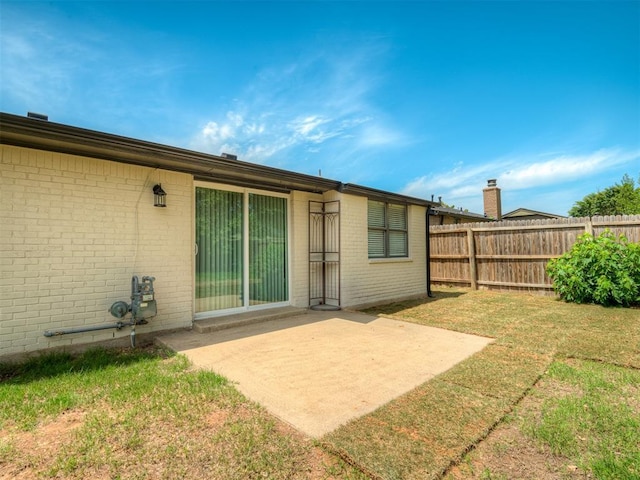 813 Branchwood Ct, Norman, OK 73072 - back of property with brick siding and a patio area