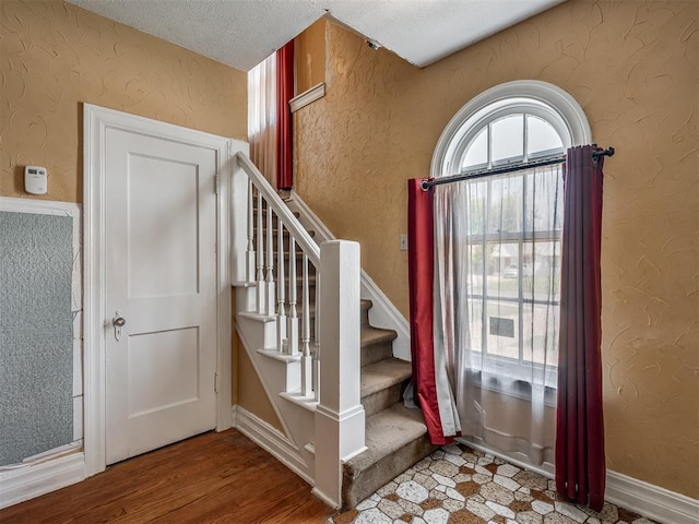 1132 SW 25th St, Oklahoma City, OK 73109 - foyer entrance with a textured ceiling, stairway, and wood finished floors