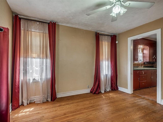 1132 SW 25th St, Oklahoma City, OK 73109 - unfurnished room featuring healthy amount of natural light, ceiling fan, wood finished floors, and baseboards