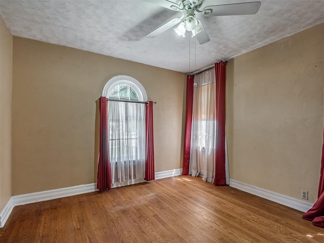 1132 SW 25th St, Oklahoma City, OK 73109 - unfurnished room with baseboards, wood finished floors, ceiling fan, and a textured ceiling