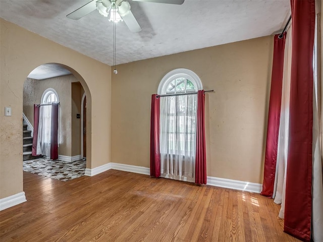 1132 SW 25th St, Oklahoma City, OK 73109 - entryway featuring arched walkways, a ceiling fan, wood finished floors, and baseboards
