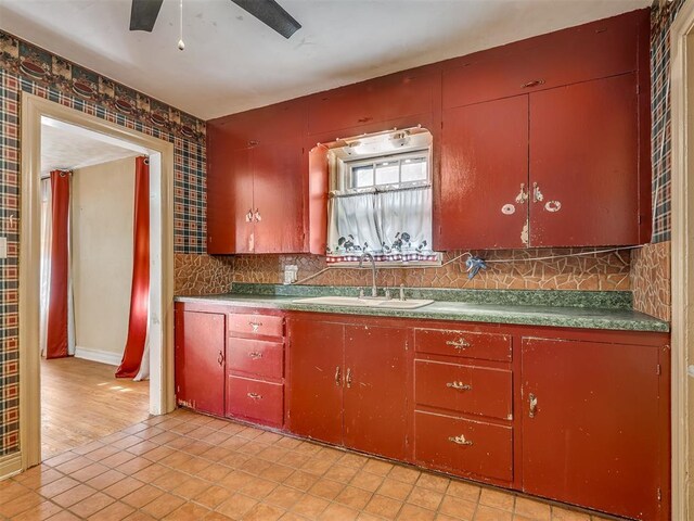 1132 SW 25th St, Oklahoma City, OK 73109 - kitchen with a sink, a ceiling fan, light tile patterned flooring, and decorative backsplash