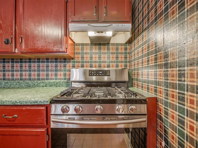1132 SW 25th St, Oklahoma City, OK 73109 - kitchen with stainless steel gas range, ventilation hood, and backsplash