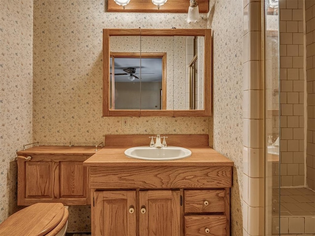 1132 SW 25th St, Oklahoma City, OK 73109 - bathroom with a shower stall, vanity, wallpapered walls, toilet, and a ceiling fan
