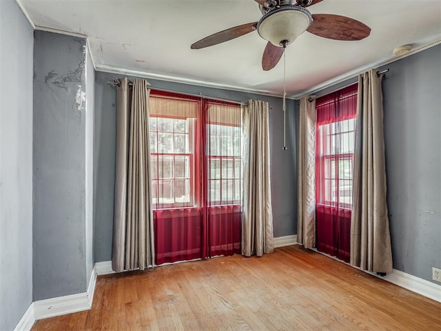 1132 SW 25th St, Oklahoma City, OK 73109 - unfurnished room with wood finished floors, ceiling fan, crown molding, baseboards, and a smoke detector
