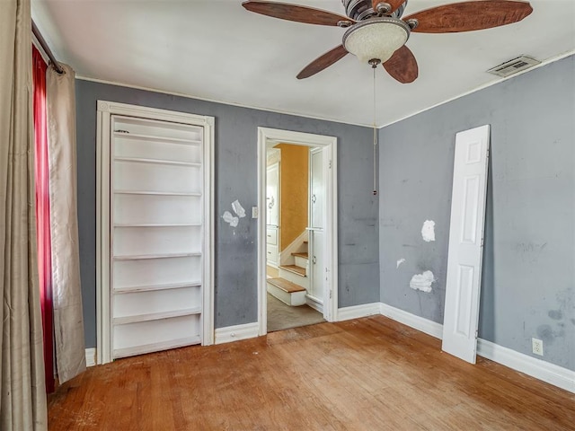 1132 SW 25th St, Oklahoma City, OK 73109 - unfurnished bedroom featuring wood finished floors, baseboards, a ceiling fan, connected bathroom, and ornamental molding