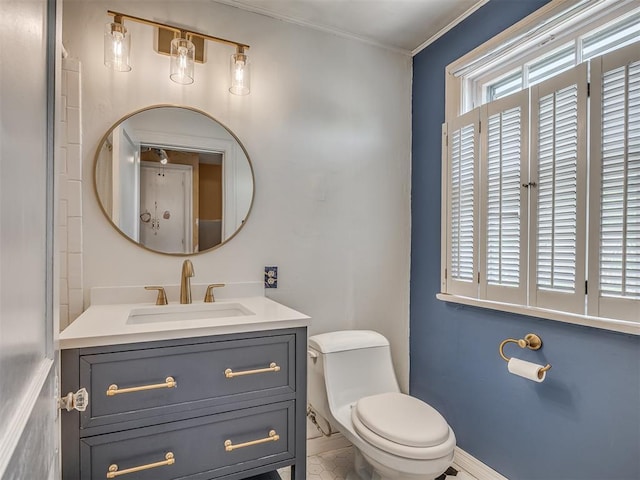 1132 SW 25th St, Oklahoma City, OK 73109 - bathroom featuring crown molding, toilet, vanity, and baseboards