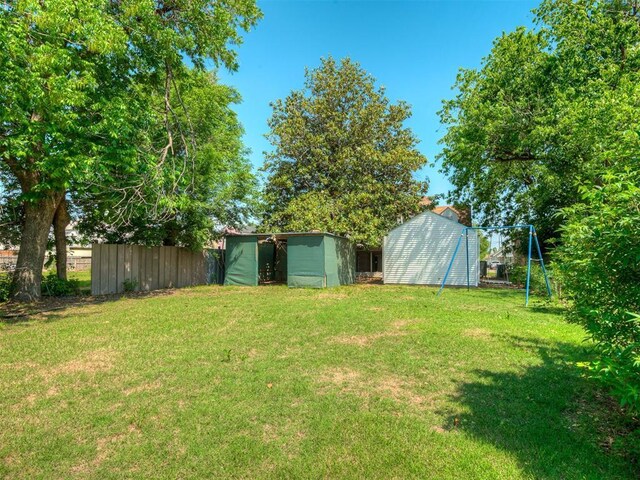 1132 SW 25th St, Oklahoma City, OK 73109 - view of yard with a storage unit and an outbuilding