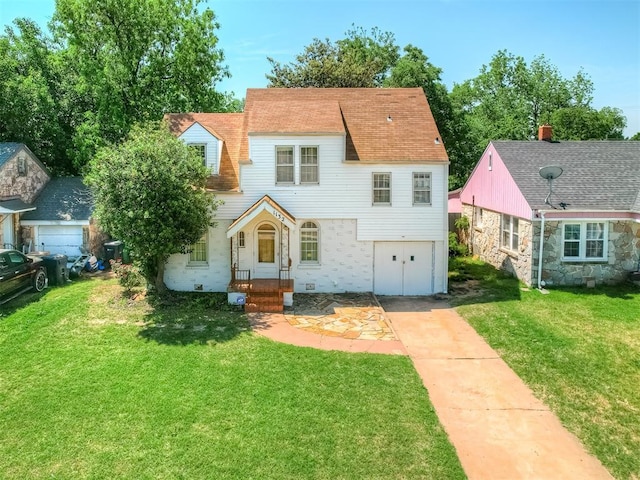 1132 SW 25th St, Oklahoma City, OK 73109 - view of front of property featuring concrete driveway, a garage, and a front lawn