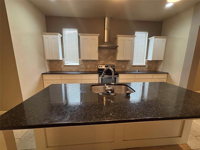 11308 NW 103rd St, Yukon, OK 73099 - kitchen featuring wall chimney exhaust hood, electric stove, a sink, decorative backsplash, and white cabinetry