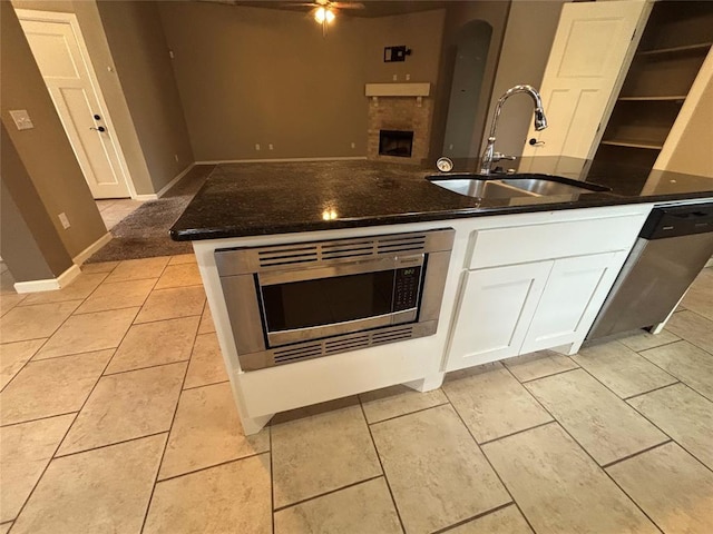 11308 NW 103rd St, Yukon, OK 73099 - kitchen with a sink, stainless steel appliances, dark stone countertops, white cabinets, and open floor plan