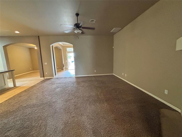 11308 NW 103rd St, Yukon, OK 73099 - unfurnished room featuring arched walkways, a ceiling fan, baseboards, and carpet floors