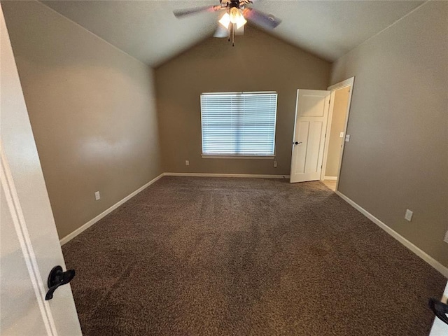 11308 NW 103rd St, Yukon, OK 73099 - spare room with a ceiling fan, lofted ceiling, dark carpet, and baseboards
