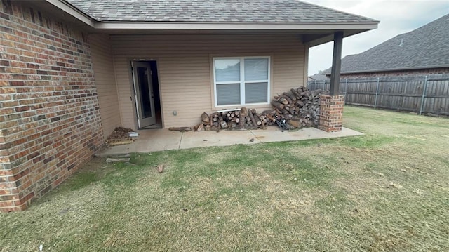 11308 NW 103rd St, Yukon, OK 73099 - doorway to property featuring a shingled roof, a patio area, and brick siding
