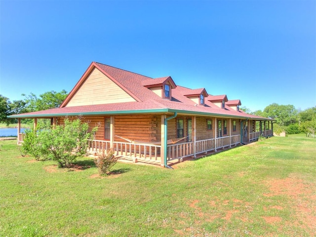 view of side of property with covered porch and a yard