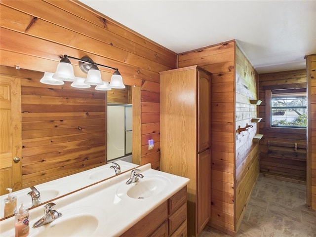 bathroom featuring wood walls and double vanity