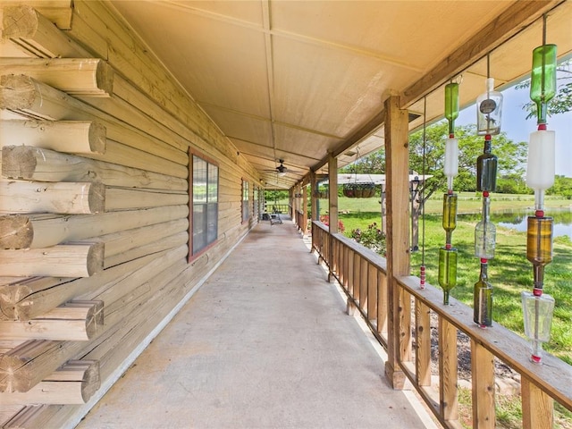 view of patio / terrace featuring covered porch and a water view