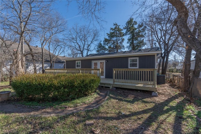 1925 NW 36th St, Oklahoma City, OK 73118 - rear view of property featuring a deck, fence, central AC, and french doors