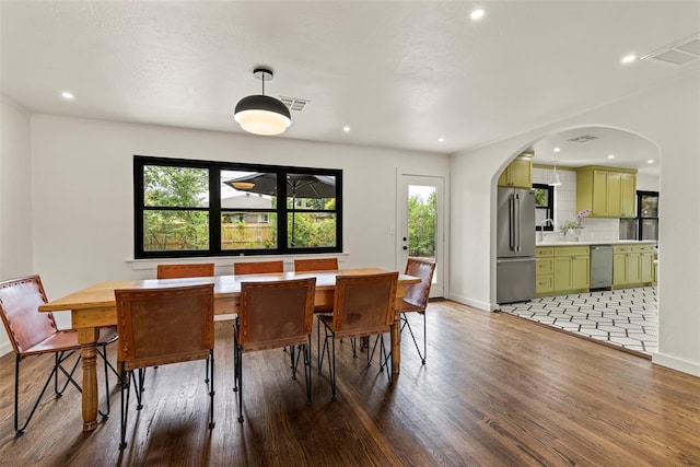 3236 NW 68th St, Oklahoma City, OK 73116 - dining room featuring arched walkways, light wood-type flooring, baseboards, and recessed lighting