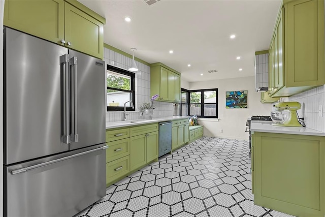 3236 NW 68th St, Oklahoma City, OK 73116 - kitchen with high end appliances, green cabinetry, a sink, light countertops, and recessed lighting