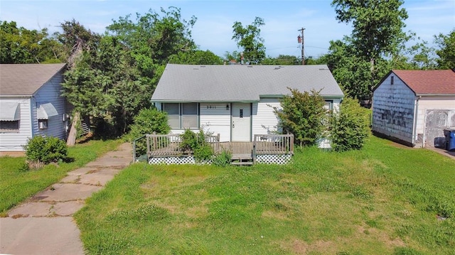 rear view of property with a lawn and a deck