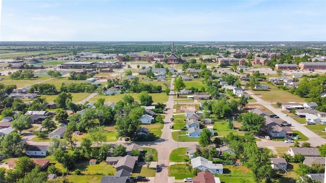 aerial view of property and surrounding area featuring nearby suburban area