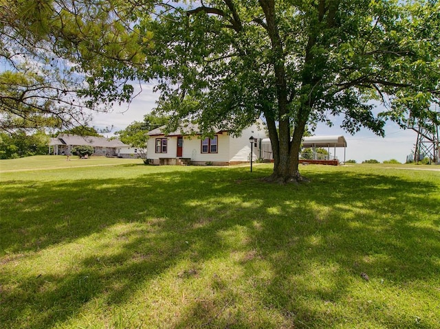 922 W 7th St, Stroud, OK 74079 - view of grassy yard featuring a carport