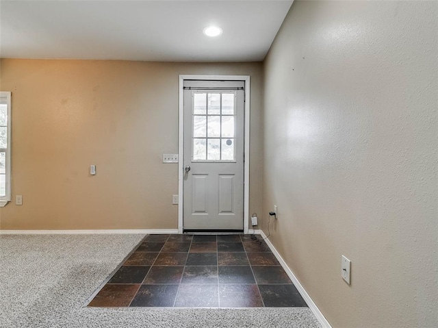 922 W 7th St, Stroud, OK 74079 - doorway featuring baseboards and dark stone finish floors