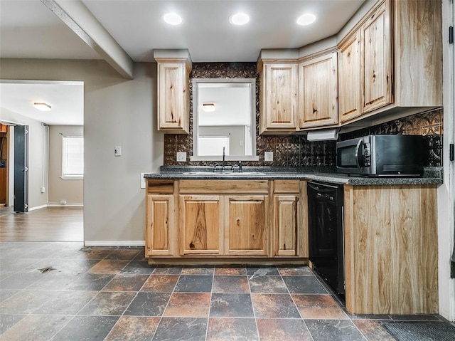 922 W 7th St, Stroud, OK 74079 - kitchen with black appliances, baseboards, dark countertops, tasteful backsplash, and a sink
