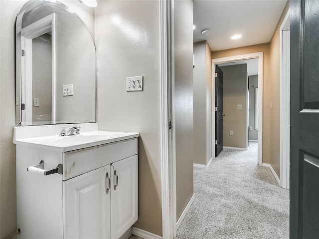 922 W 7th St, Stroud, OK 74079 - bathroom with baseboards, vanity, and recessed lighting