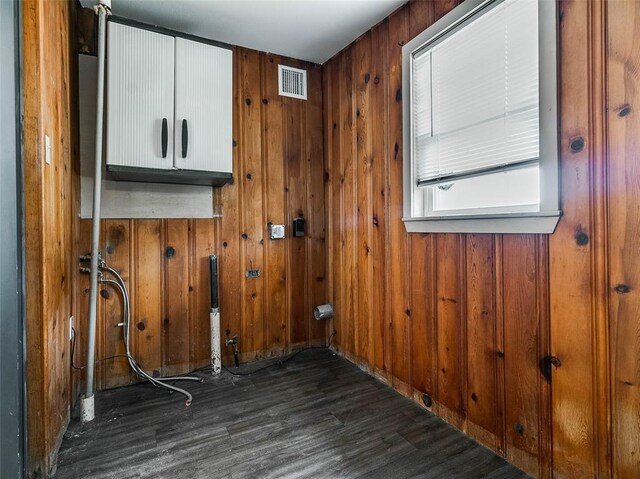 922 W 7th St, Stroud, OK 74079 - washroom with wood finished floors, cabinet space, and wood walls