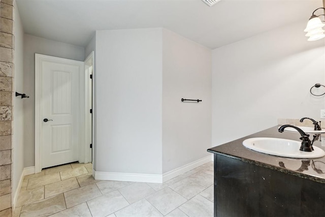 full bath featuring baseboards and vanity