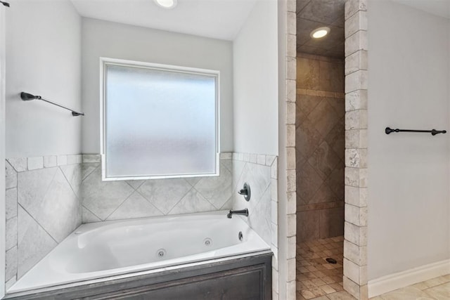 full bath featuring a tub with jets and a tile shower