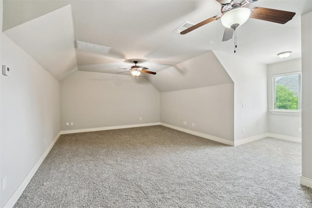 additional living space with a ceiling fan, carpet, baseboards, and vaulted ceiling