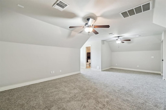 additional living space featuring carpet, a ceiling fan, baseboards, and vaulted ceiling