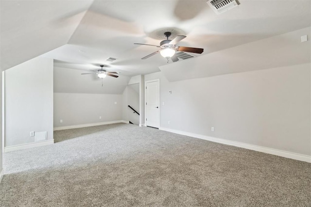 bonus room with ceiling fan, vaulted ceiling, carpet flooring, and baseboards