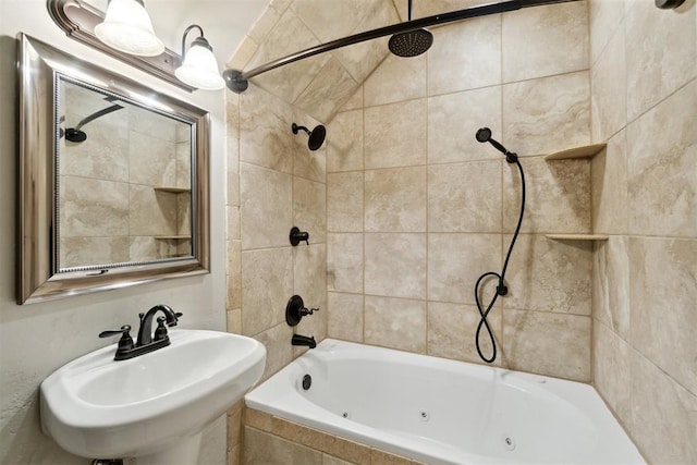 bathroom with a sink and a combined bath / shower with jetted tub