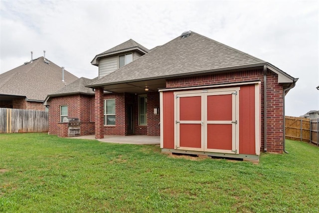 rear view of house with brick siding, a shingled roof, and a patio area