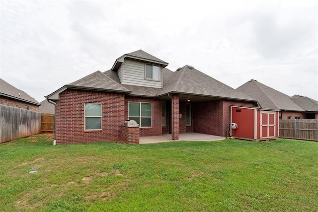 rear view of property with brick siding, roof with shingles, and a patio area