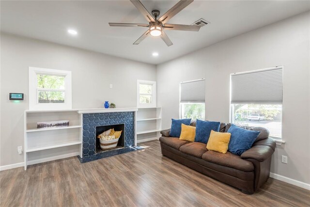 1717 N Kelham Ave, Oklahoma City, OK 73111 - living area with wood finished floors, a ceiling fan, baseboards, a stone fireplace, and recessed lighting