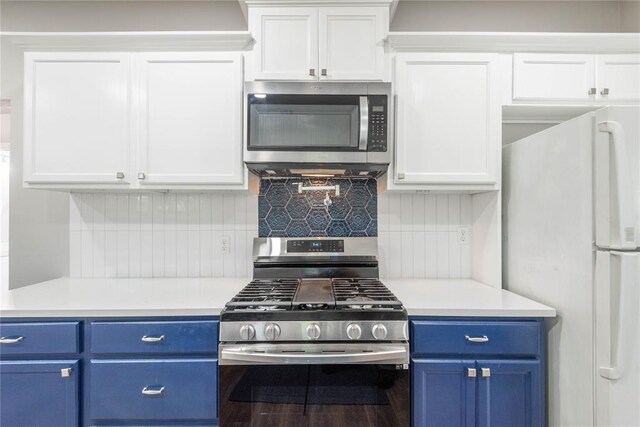 1717 N Kelham Ave, Oklahoma City, OK 73111 - kitchen with stainless steel appliances, blue cabinets, light countertops, and white cabinetry