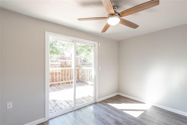 1717 N Kelham Ave, Oklahoma City, OK 73111 - spare room with baseboards, wood finished floors, and a ceiling fan