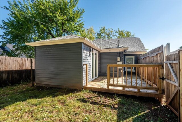 1717 N Kelham Ave, Oklahoma City, OK 73111 - rear view of house with roof with shingles and a wooden deck
