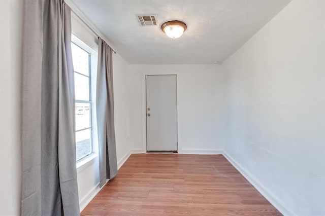 spare room with light wood finished floors and baseboards